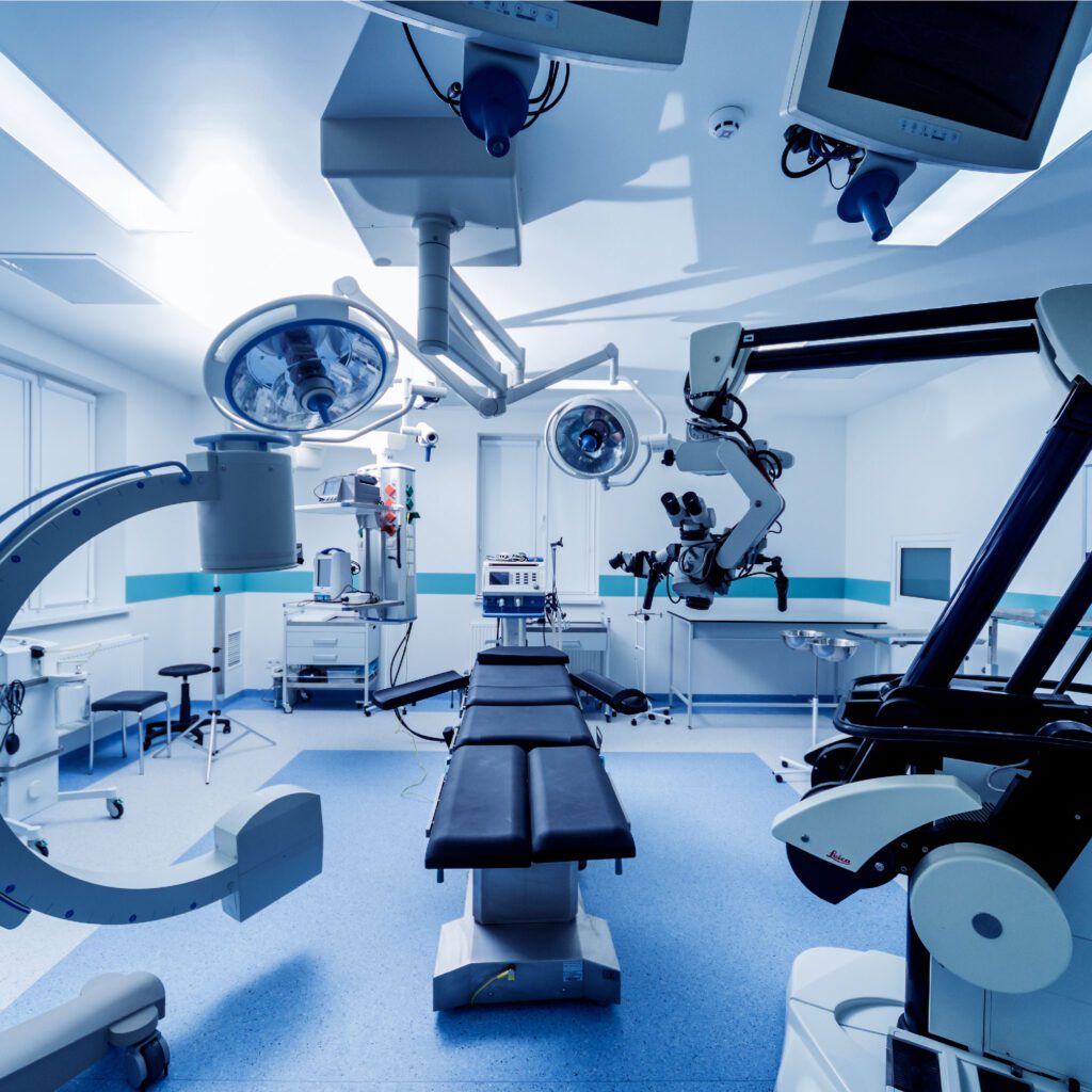 A hospital operating room with surgical equipment and medical devices.