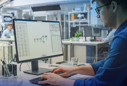 A man working on a computer at his desk.