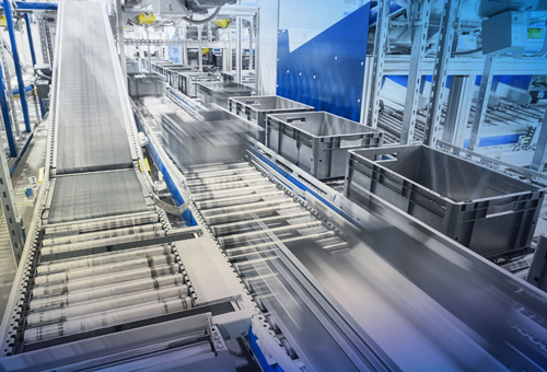 A conveyor belt with many boxes on it