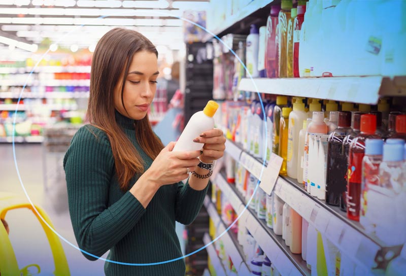 A woman looking at an item in a store.