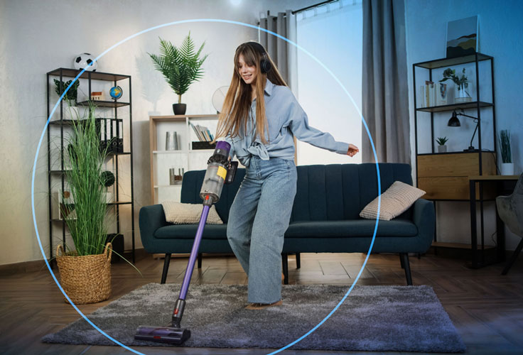 A woman is vacuuming in the living room