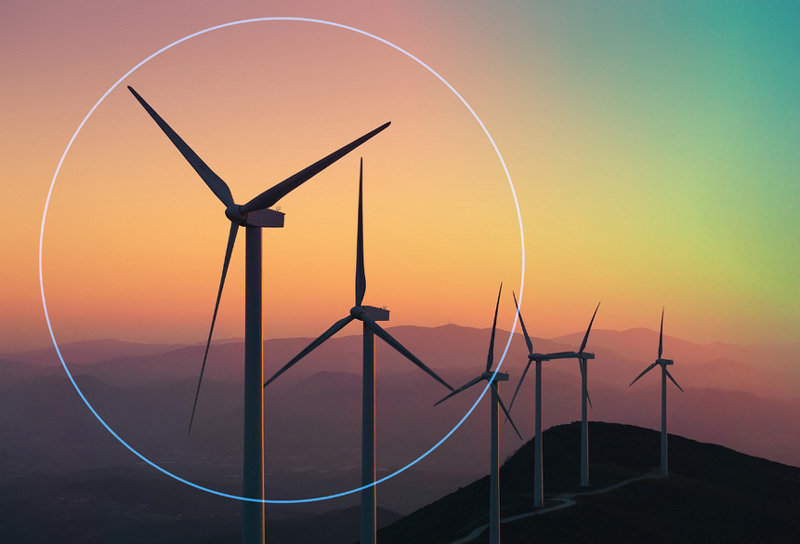 A group of wind turbines on top of a hill.