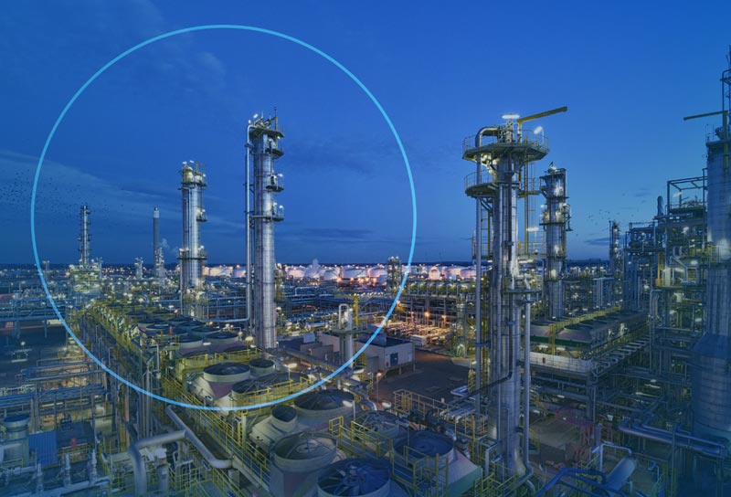 A large oil refinery with many towers and buildings.