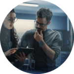 A man and woman looking at an ipad.