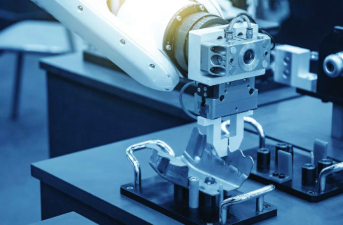 A robotic arm is shown on top of some machinery.