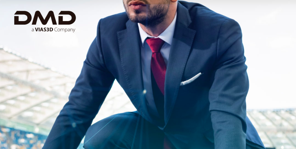 A man in a suit and tie sitting on the ground.