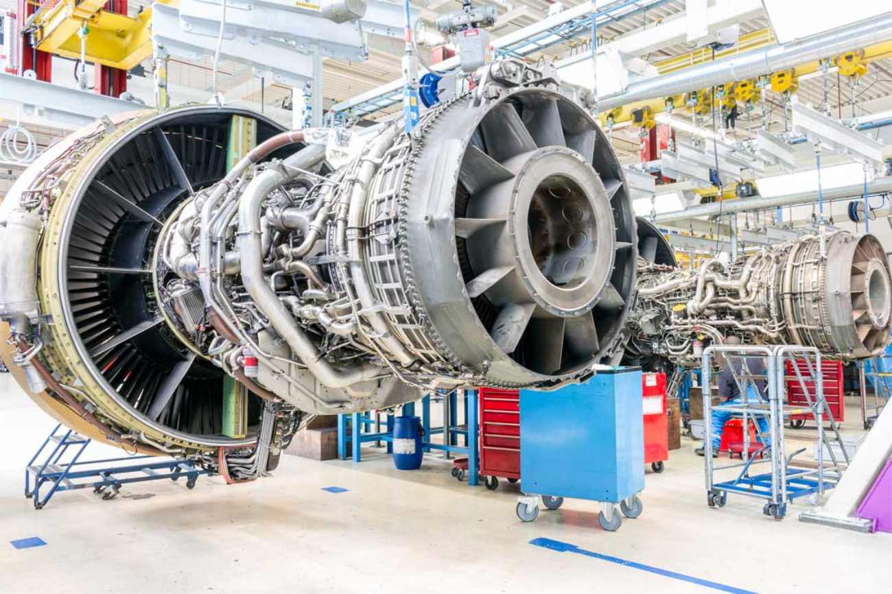 A large jet engine in an aircraft maintenance facility.