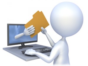 A person is holding a folder and touching the screen of a laptop.