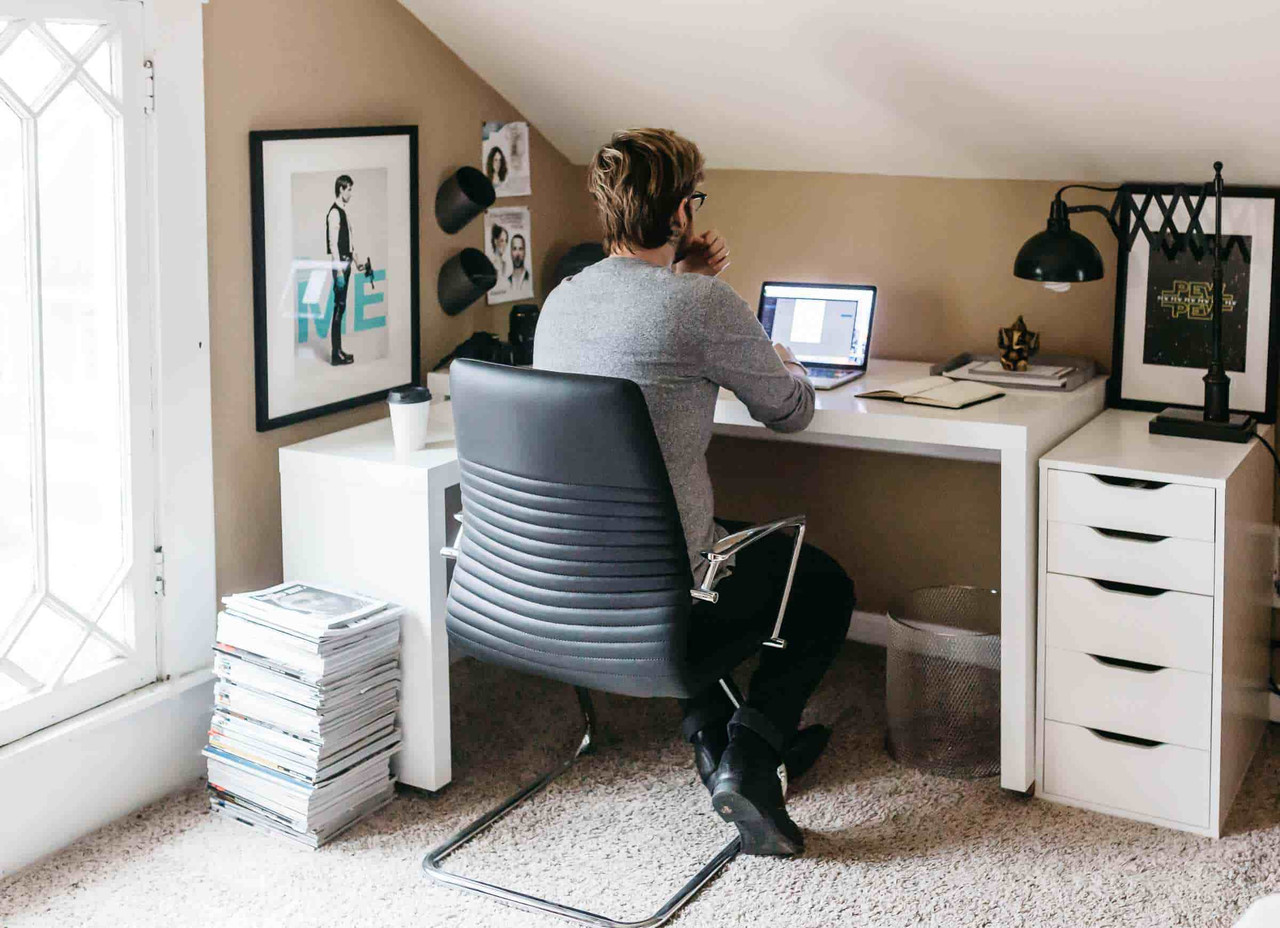 A person sitting at a desk with a laptop