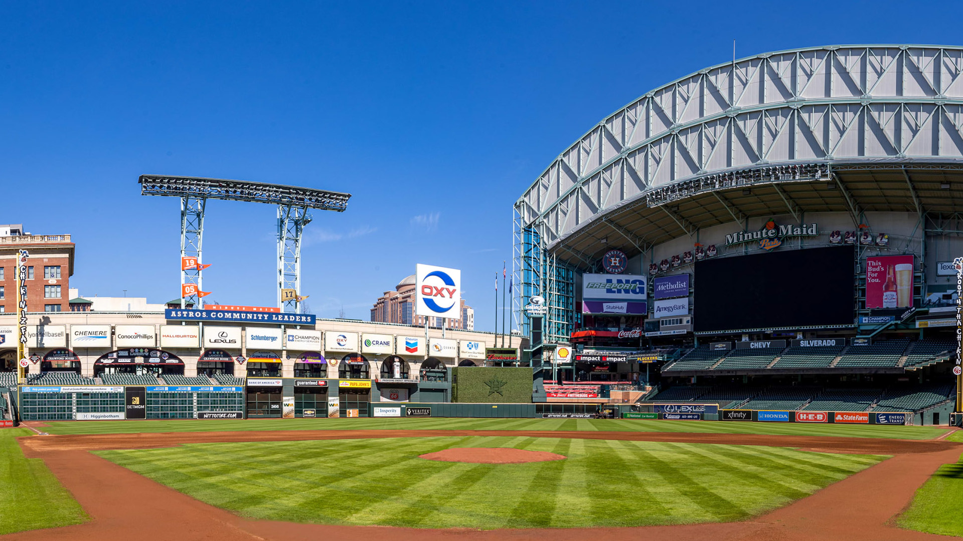A baseball field with the stadium in the background.