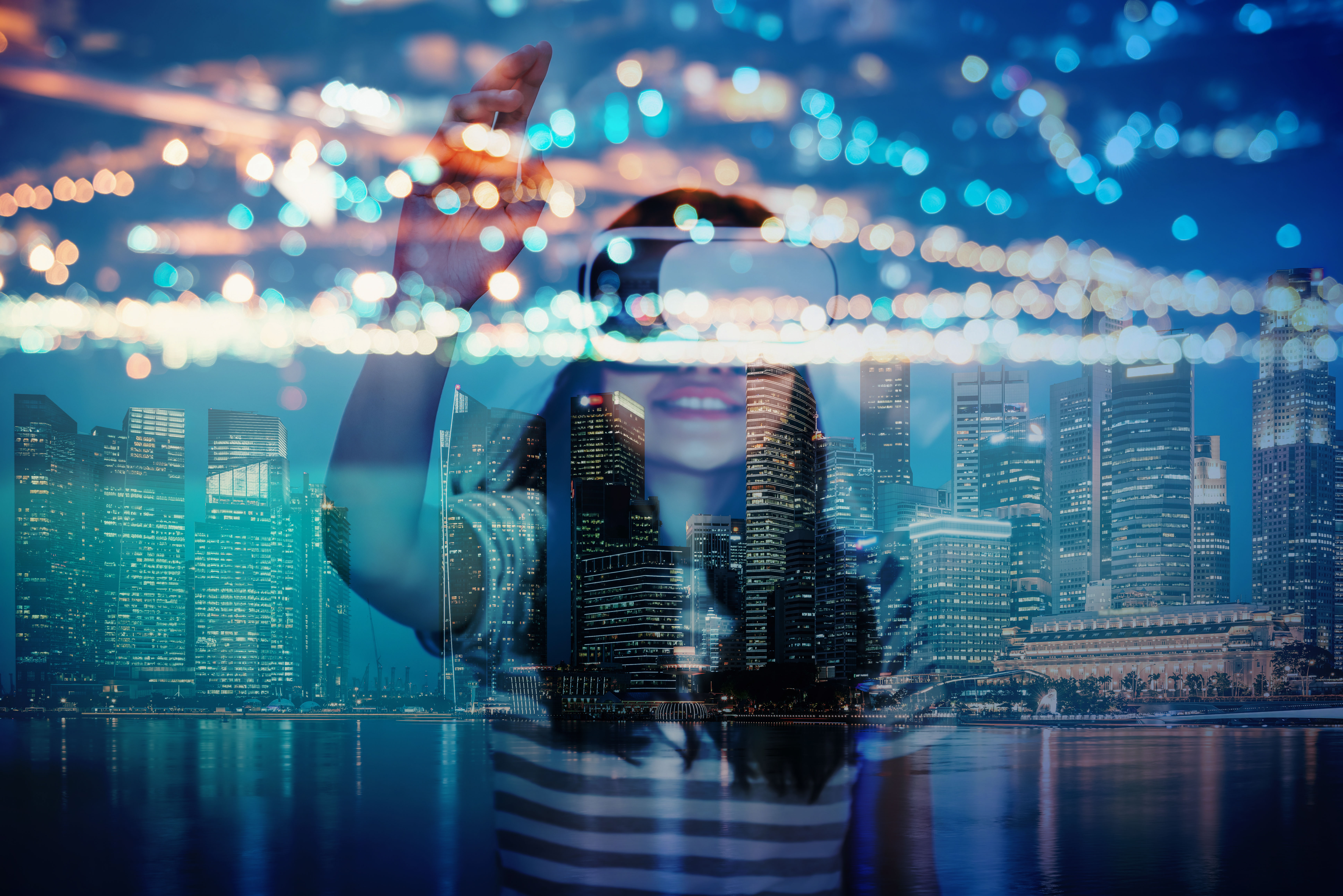 A woman is holding her phone in front of the city lights.