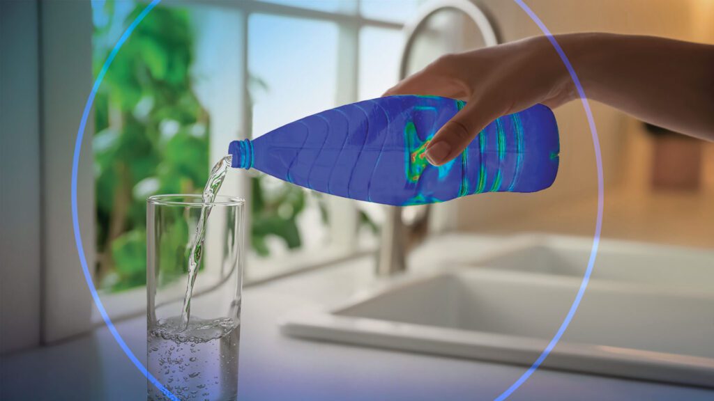 A person is pouring water into a glass.